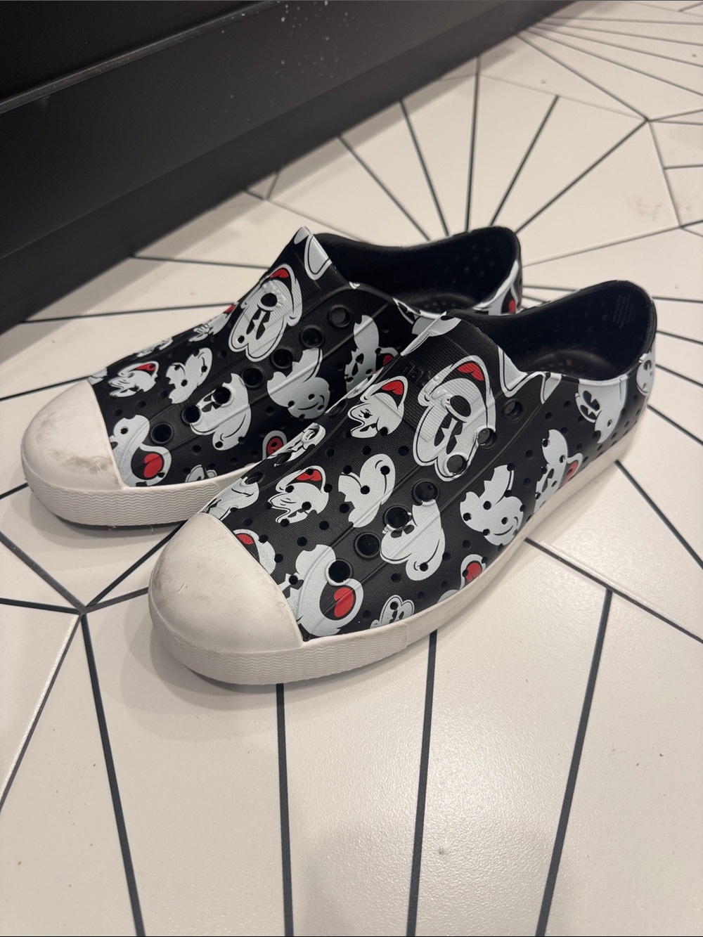Native Shoes Black White and Red Cartoon Slip-On Sneakers